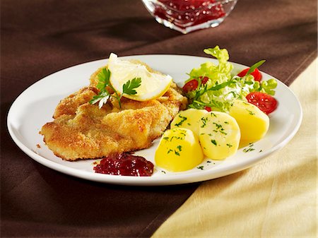Wiener Schnitzel (breaded veal escalope), parsley potatoes & cranberries Stock Photo - Premium Royalty-Free, Code: 659-03536775