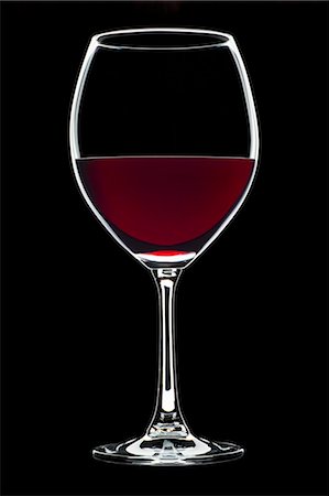 Glass of red wine against black background Stock Photo - Premium Royalty-Free, Code: 659-03536786