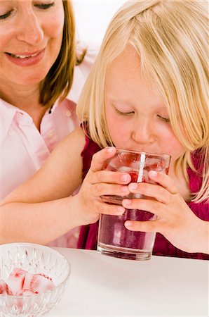 Girl drinking water with raspberry ice cubes Stock Photo - Premium Royalty-Free, Code: 659-03536934