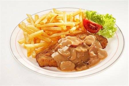Pork escalope with chips and mushroom sauce Stock Photo - Premium Royalty-Free, Code: 659-03536982