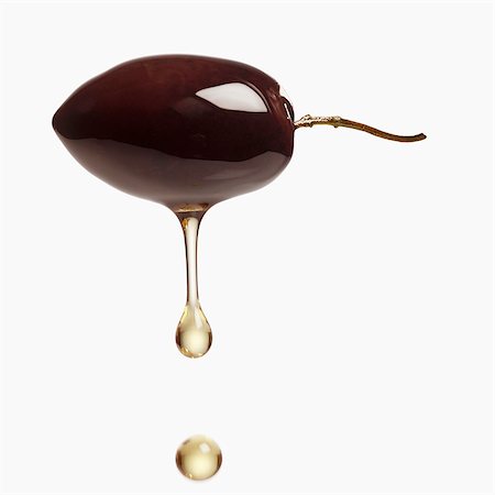 Olive oil dripping from black olive Foto de stock - Sin royalties Premium, Código: 659-03537156