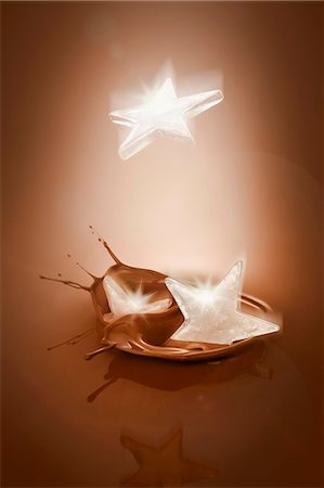 Ice stars falling into melted chocolate Stock Photo - Premium Royalty-Free, Code: 659-03537160