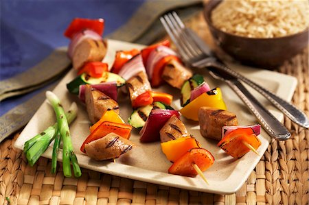 Grilled Sausage and Vegetable Kabobs on a Plate; Knife and Fork Stock Photo - Premium Royalty-Free, Code: 659-03537179