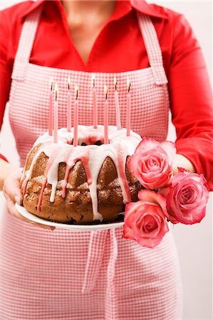 pastry display - Woman holding ring cake and roses for a birthday Stock Photo - Premium Royalty-Free, Code: 659-03537225