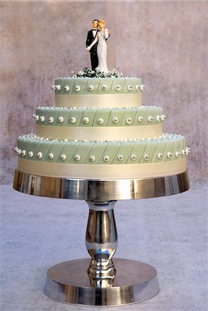 Three-tiered wedding cake with bride and groom cake toppers Stock Photo - Premium Royalty-Free, Code: 659-03537574
