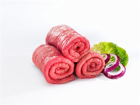 Raw beef for roulades with onion rings and lettuce leaf Stock Photo - Premium Royalty-Free, Code: 659-03537636