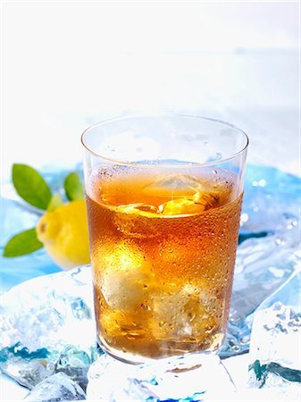 fruit icecubes - A glass of iced tea on ice with lemon Stock Photo - Premium Royalty-Free, Code: 659-03537646