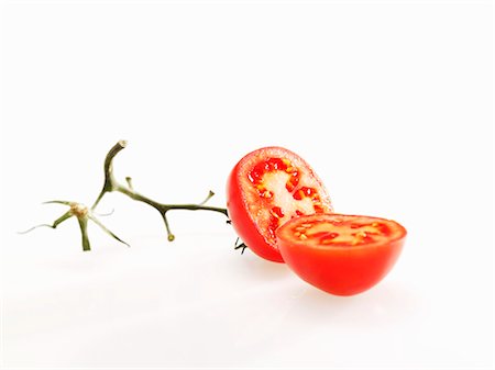 Halved tomato with stalk Stock Photo - Premium Royalty-Free, Code: 659-03537642