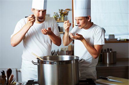 pots on a stove - Two chefs tasting soup out of pan Stock Photo - Premium Royalty-Free, Code: 659-03537663