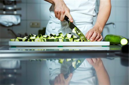 food movement - Chef chopping courgettes Stock Photo - Premium Royalty-Free, Code: 659-03537675