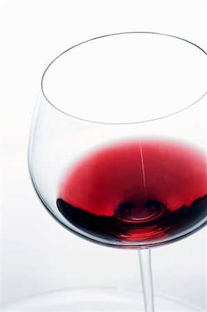 A little red wine in a glass Stock Photo - Premium Royalty-Free, Code: 659-03537883