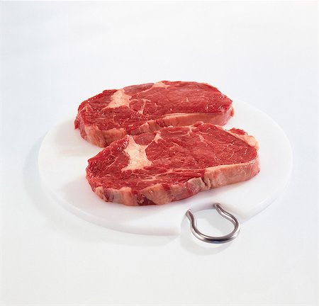 Two steaks from the fore rib on a board Stock Photo - Premium Royalty-Free, Code: 659-03530055