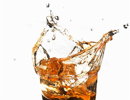 drop glass - Apple juice splashing out of a glass Stock Photo - Premium Royalty-Free, Code: 659-03530113