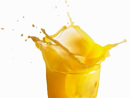 squirting - Orange juice splashing out of a glass Stock Photo - Premium Royalty-Free, Code: 659-03530152