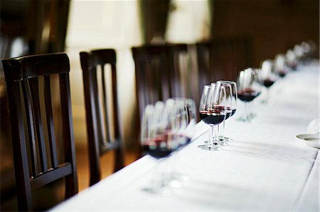 Table laid in white with glasses of red wine Stock Photo - Premium Royalty-Free, Code: 659-03530259