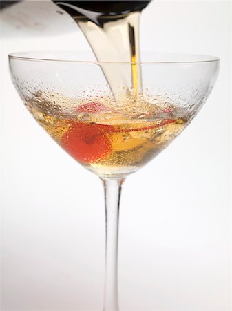 Pouring Manhattan out of cocktail shaker into glass Stock Photo - Premium Royalty-Free, Code: 659-03530454