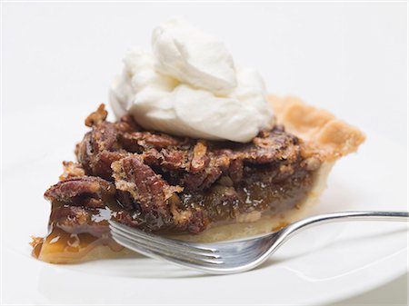 Piece of pecan pie with cream Stock Photo - Premium Royalty-Free, Code: 659-03530479
