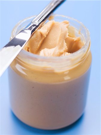 peanut butter - Peanut butter in jar with knife Stock Photo - Premium Royalty-Free, Code: 659-03530523