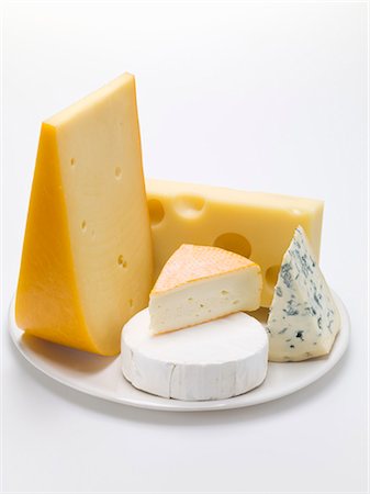 Pieces of different cheeses on plate Stock Photo - Premium Royalty-Free, Code: 659-03530651