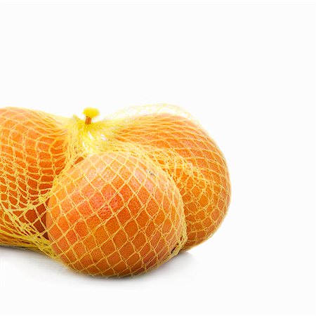 simsearch:659-03534444,k - Three grapefruits in a net Stock Photo - Premium Royalty-Free, Code: 659-03530716