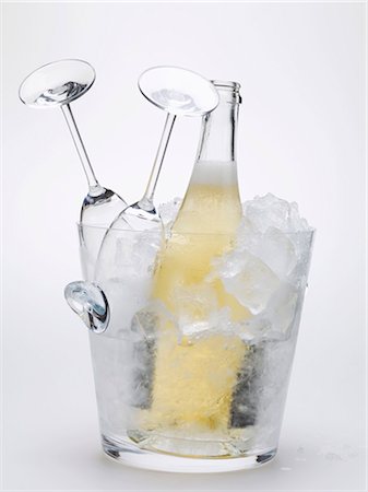 picture of champagne bottle and champagne flute - Bottle of sparkling wine & two empty wine glasses in ice bucket Stock Photo - Premium Royalty-Free, Code: 659-03530749