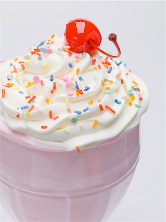 Milkshake with cream, sprinkles & cocktail cherry (close-up) Stock Photo - Premium Royalty-Free, Code: 659-03530760