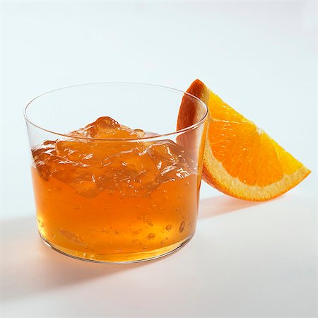 Orange jelly in glass, orange wedge beside it Foto de stock - Sin royalties Premium, Código: 659-03530906