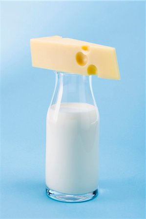 Piece of Emmental cheese on bottle of milk Stock Photo - Premium Royalty-Free, Code: 659-03530917