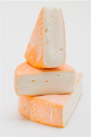simsearch:659-03528072,k - Three pieces of washed-rind cheese Stock Photo - Premium Royalty-Free, Code: 659-03530926