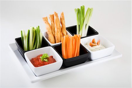 snack recipe - Tray of vegetable sticks, savoury straws and dips Stock Photo - Premium Royalty-Free, Code: 659-03531049