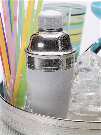 drink shaker - A cocktail shaker, ice cubes, glasses and straws Stock Photo - Premium Royalty-Free, Code: 659-03531060