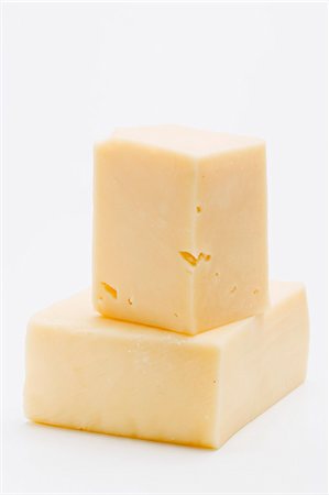 Two pieces of Cheddar cheese Stock Photo - Premium Royalty-Free, Code: 659-03531125