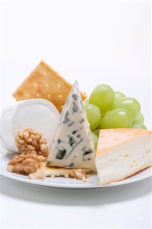 Cheese plate with crackers, nuts and grapes Stock Photo - Premium Royalty-Free, Code: 659-03531149