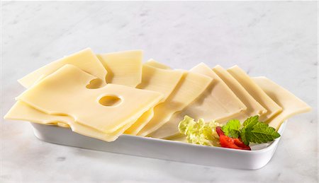 Several slices of Emmental cheese Stock Photo - Premium Royalty-Free, Code: 659-03531171