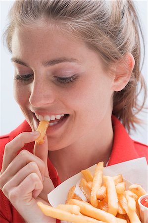 fatty - Young woman eating a bag of chips Stock Photo - Premium Royalty-Free, Code: 659-03531210