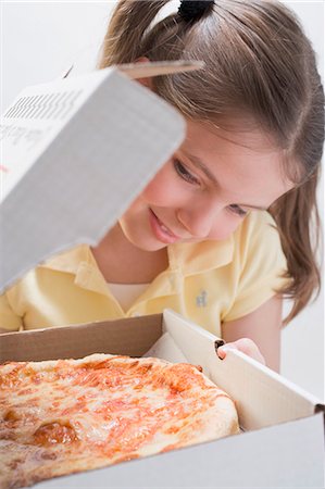 people enjoy pizza - Girl looking at fresh pizza in pizza box Stock Photo - Premium Royalty-Free, Code: 659-03531230