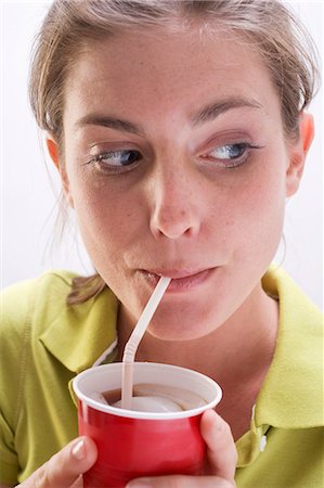 soda - Young woman in green blouse drinking cola Stock Photo - Premium Royalty-Free, Code: 659-03531249