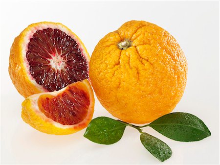 Blood oranges with leaves Stock Photo - Premium Royalty-Free, Code: 659-03531272