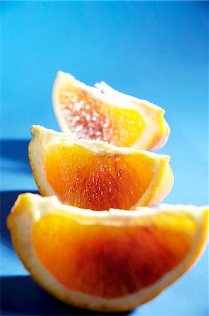 Three wedges of blood orange Stock Photo - Premium Royalty-Free, Code: 659-03531641