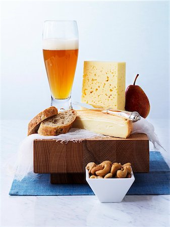 Cheese, bread, pear and wheat beer on a board Stock Photo - Premium Royalty-Free, Code: 659-03532010