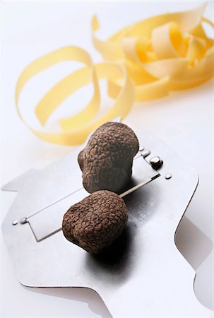 Black truffles (Chinese truffles) on truffle slicer, ribbon pasta Stock Photo - Premium Royalty-Free, Code: 659-03532205