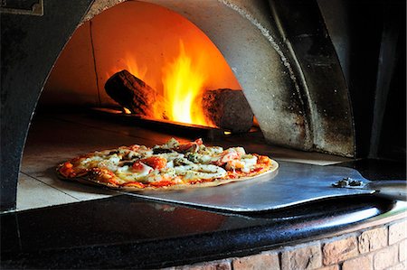 Seafood pizza in stone oven Stock Photo - Premium Royalty-Free, Code: 659-03532468