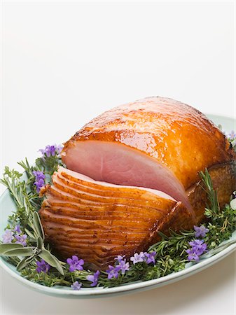 Glazed roast ham surrounded by herbs Stock Photo - Premium Royalty-Free, Code: 659-03532664