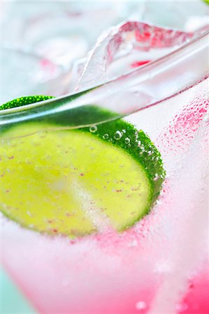 simsearch:659-03523706,k - A glass of raspberry soda with ice cubes and lime slices Stock Photo - Premium Royalty-Free, Code: 659-03532764