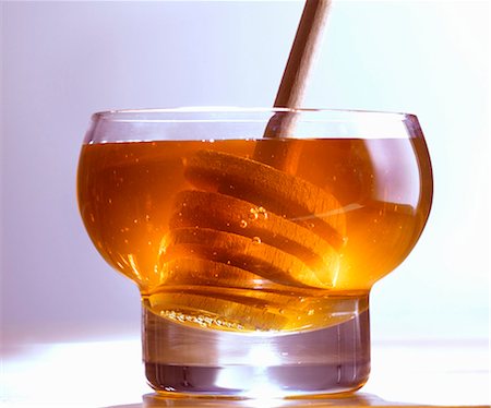 Honey in glass with honey dipper Stock Photo - Premium Royalty-Free, Code: 659-03532877