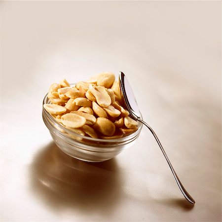 peanut - Salted peanuts in glass dish with spoon Stock Photo - Premium Royalty-Free, Code: 659-03532886