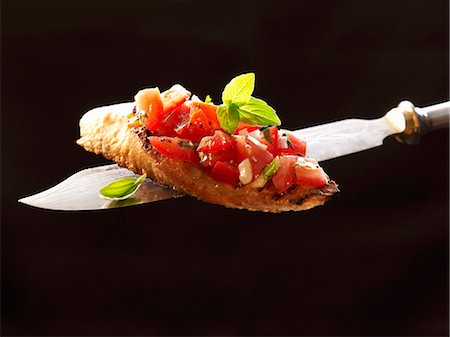 Bruschetta on a knife Stock Photo - Premium Royalty-Free, Code: 659-03533107