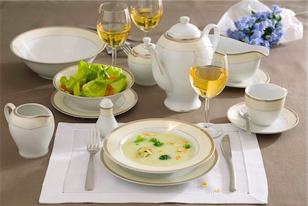 Place-setting with broccoli soup, salad and white wine Stock Photo - Premium Royalty-Free, Code: 659-03533145