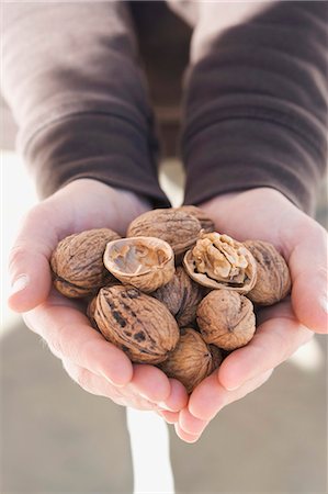 Hands holding walnuts Stock Photo - Premium Royalty-Free, Code: 659-03533494