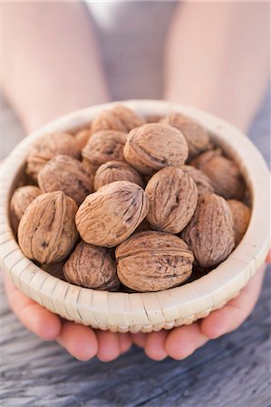 Hands holding basket of walnuts Stock Photo - Premium Royalty-Free, Code: 659-03533492